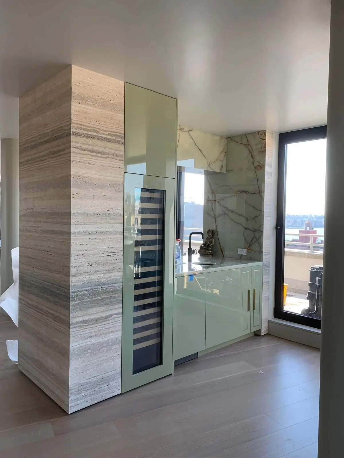 Pale lacquer pantry cabinetry with an integrated wine column
