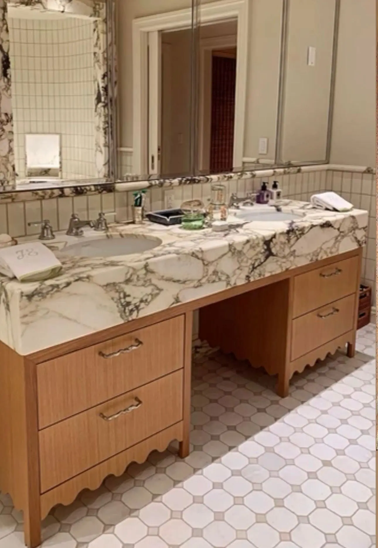 Double vanity in warm wood with a marble top